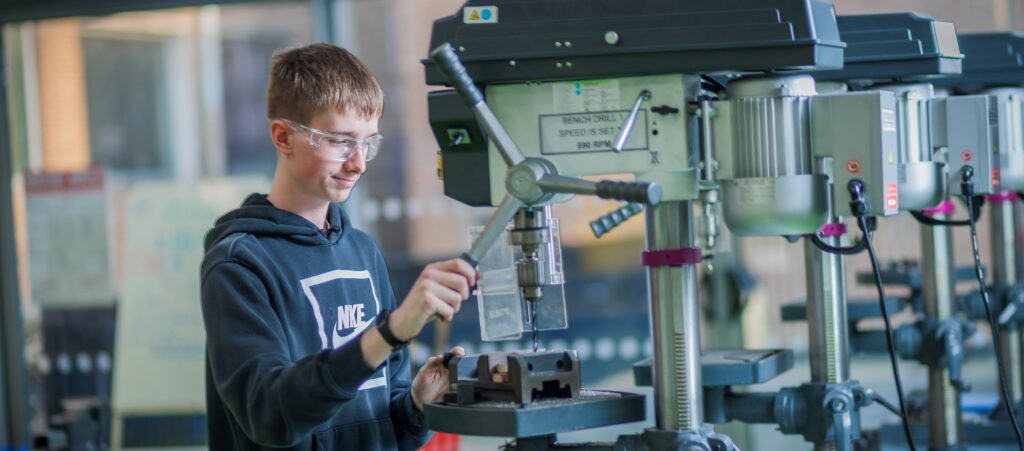 male student working a machine