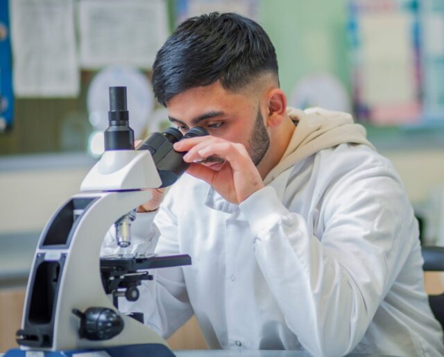 Student looking through microscope