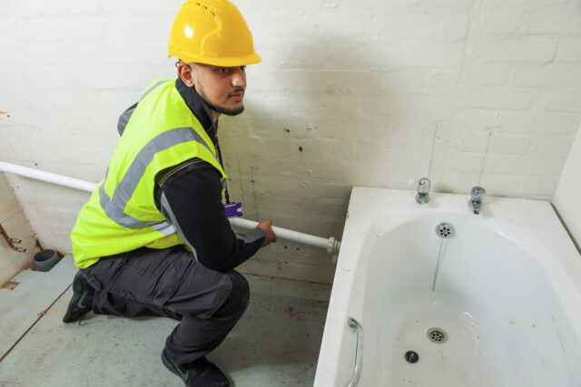 Student plumbing in bath