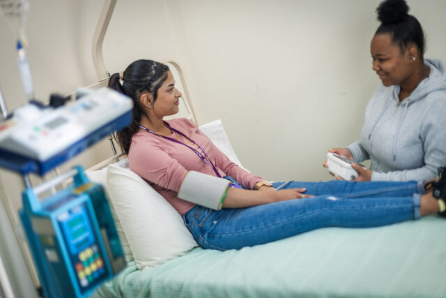 Student having blood pressure taken