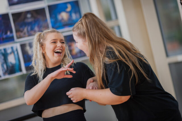 Two students laughing