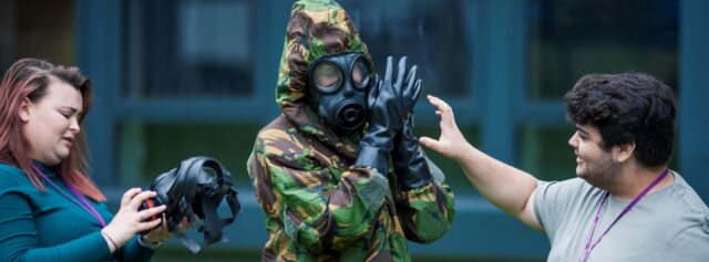 Student getting dressed in protective uniform
