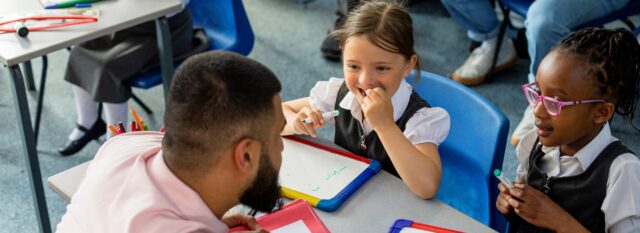 Male teacher with primary school pupils