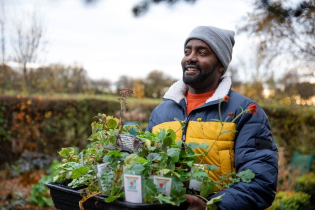Student with tray of plants