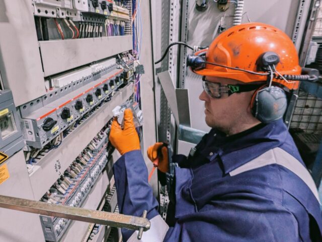 Davis working on a machine.