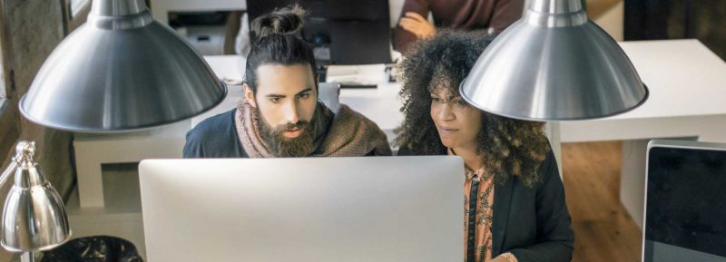 two university level students working on computer