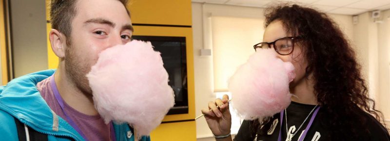 two students eating candy floss