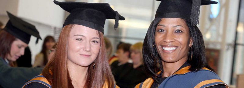 students getting ready in cap and gowns