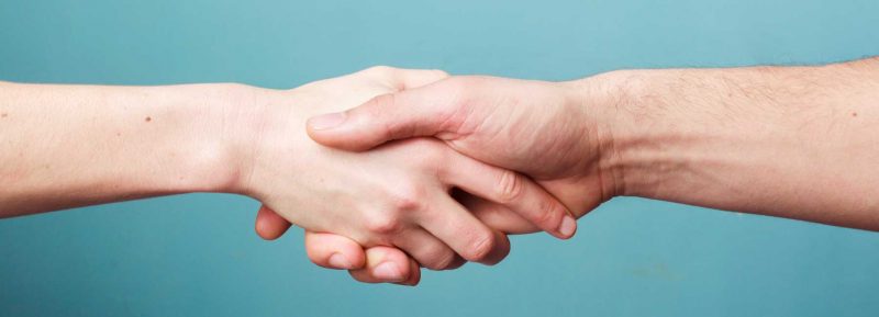 older meets young handshake