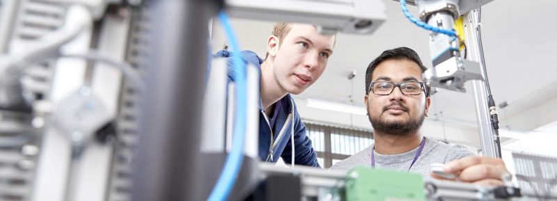 two engineering students looking at a task