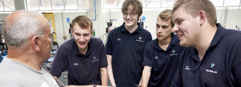 BMW apprentices with trainer