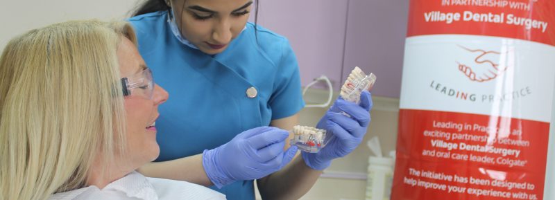 dental apprentice in consultation with patient