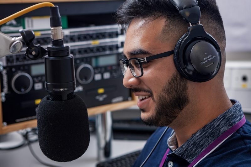 Media Student talking into microphone