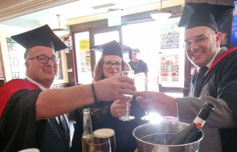 Three teachers toasting to their graduation