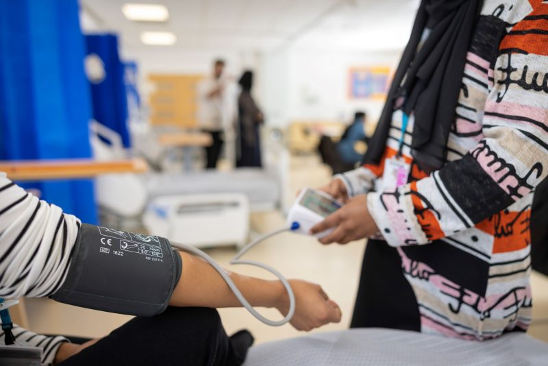 Health & Social Care student taking blood pressure