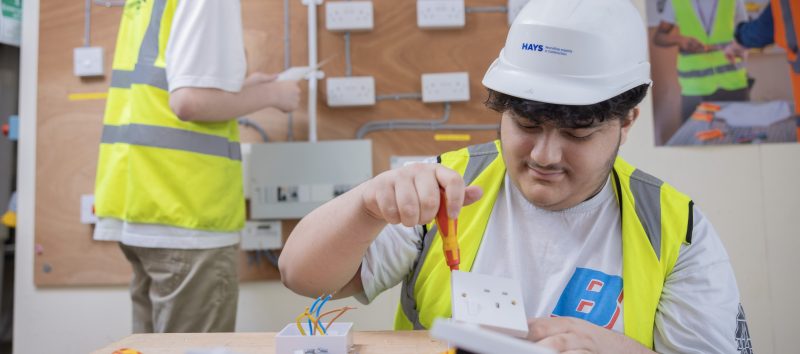 Electrical student wiring a plug socket
