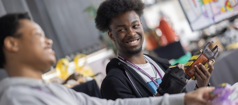 Two gaming students laughing